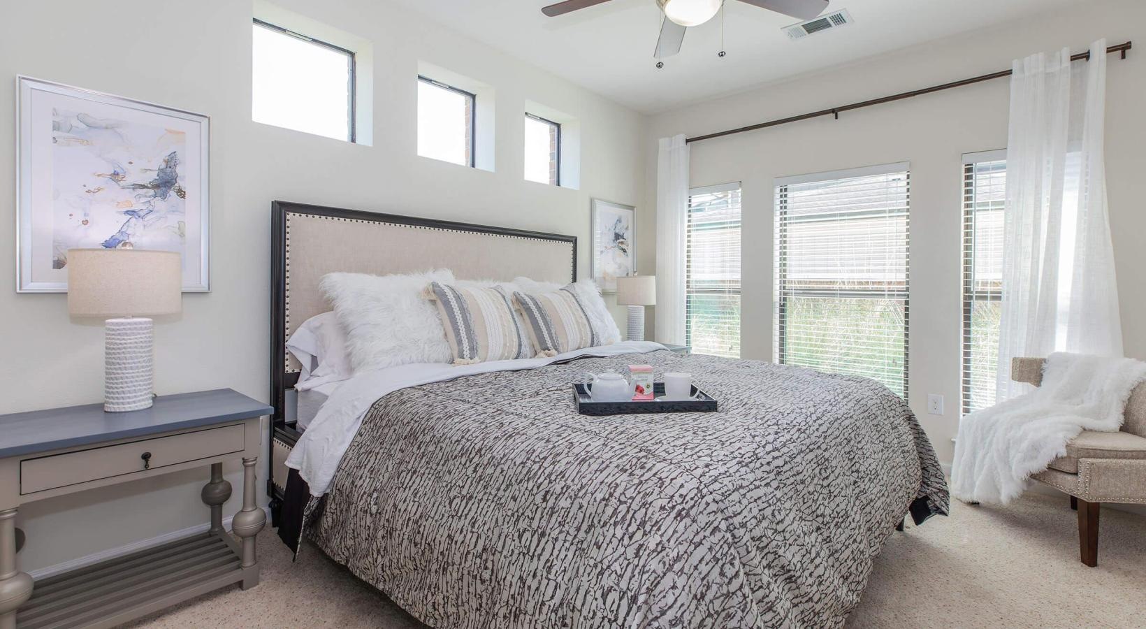 a bedroom with a bed and a fan